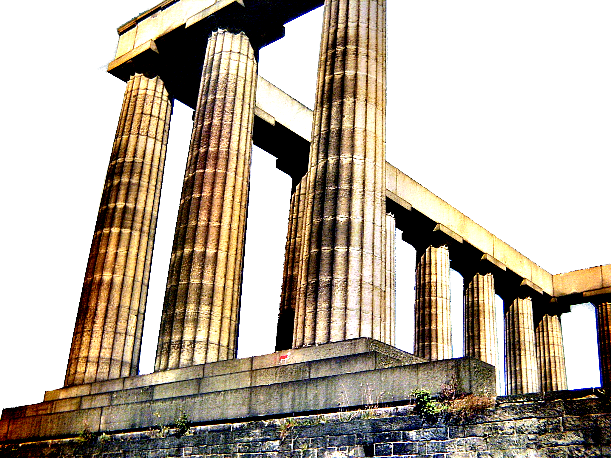 A digitally-altered view of the National Monument of Scotland at Calton Hill in Edinburgh — a row and two square corners of classical columns topped by lintels — viewed looking through the columns and upwards. The image's colours have been altered so the sky is pure white; the monument and its plinth are their natural sandstone colours, but with the contrast enhanced, so they're unnaturally bright in the sunlight and pure black in the shade.