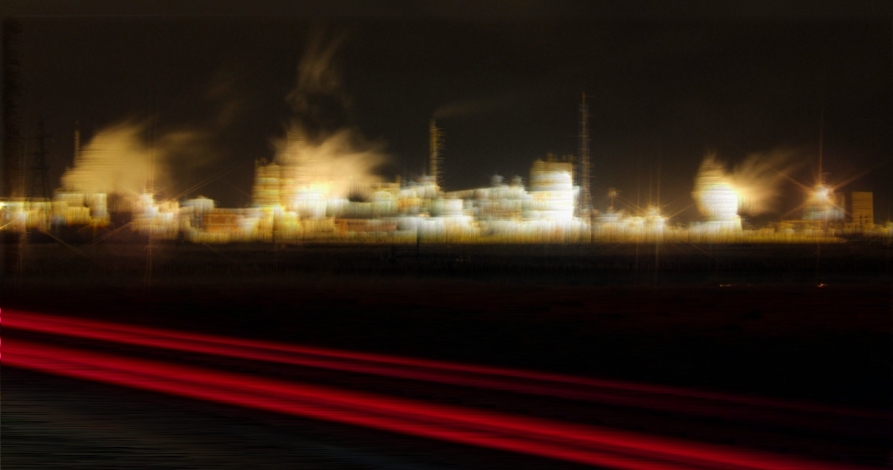 Hartlepool power station at night, a broad cluster of brightly illuminated buildings occupying the horizon in the distance, with backlit plumes of steam; 2 pairs of red car light streaks, made by long exposure, mark the road in the foreground. The image has an artificial brushstroke texture applied, brushing the light colours rightward and the dark colours diagonally up-right, in digitally-thin extrusions. Compared to the original photo, which captures a realistic view of the power station, this remix turns the buildings into an abstract collection of artificial creamy-beige shapes and textures.